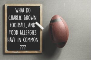 American football next to a sign that reads, "What do Charlie Brown, football, and food allergies have in common?"